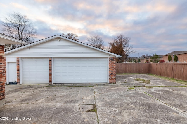 view of garage at dusk