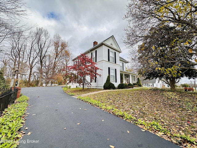 205 W Chestnut St, Leitchfield, KY 42754 - view of side of property featuring a chimney
