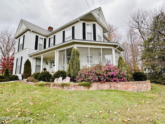 205 W Chestnut St, Leitchfield, KY 42754 - view of front of property featuring a sunroom, a chimney, and a front yard