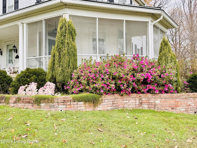 view of home's exterior with a sunroom