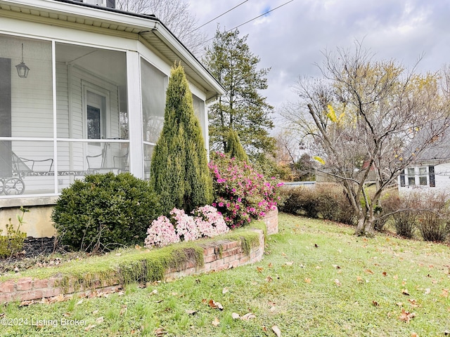 view of yard featuring a sunroom