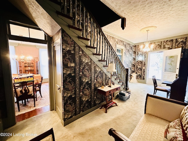 living room featuring light carpet, plenty of natural light, and a notable chandelier