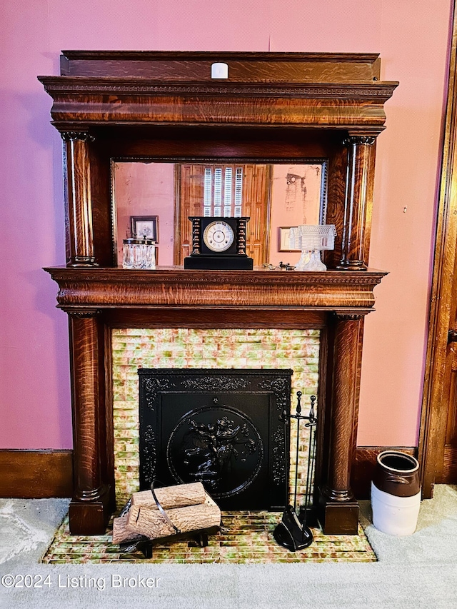 interior details with carpet flooring and a tile fireplace