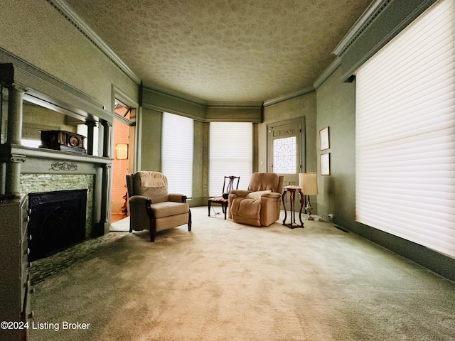 living area featuring crown molding, a fireplace, carpet, and a textured ceiling