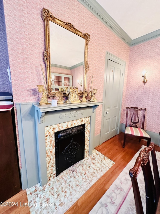 sitting room with hardwood / wood-style flooring and ornamental molding