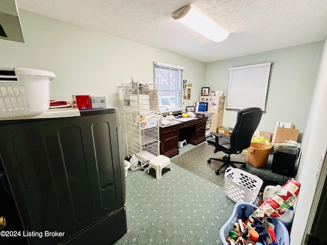 office featuring carpet flooring, washer / dryer, and a textured ceiling