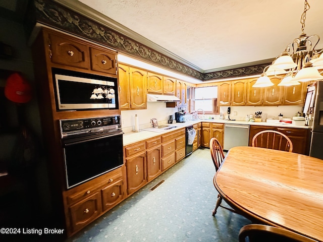 kitchen with a textured ceiling, decorative light fixtures, crown molding, and black appliances