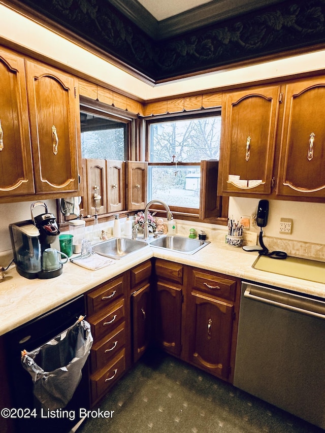 kitchen with dishwasher, crown molding, and sink