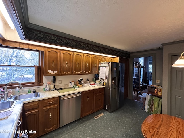 205 W Chestnut St, Leitchfield, KY 42754 - kitchen with appliances with stainless steel finishes, light countertops, plenty of natural light, ornamental molding, and a textured ceiling