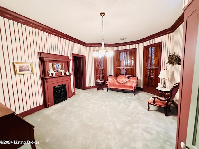 living area with a chandelier, carpet floors, and crown molding