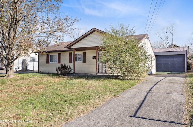 view of front facade featuring a porch, a front lawn, an outdoor structure, and a garage