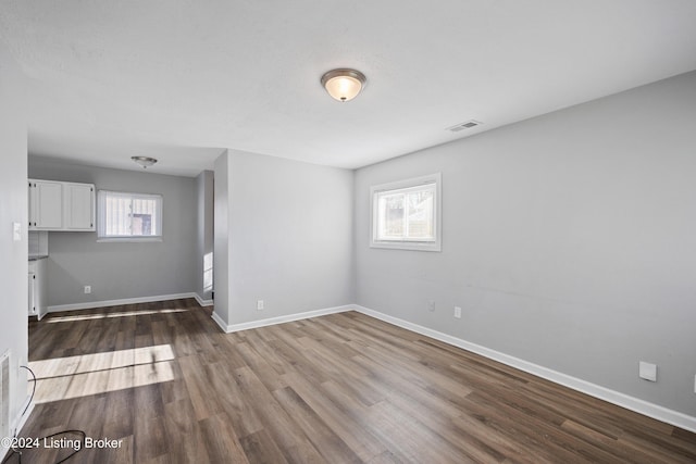 spare room featuring hardwood / wood-style floors and a healthy amount of sunlight