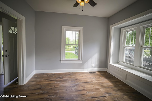 unfurnished room with dark hardwood / wood-style flooring, a wealth of natural light, and ceiling fan