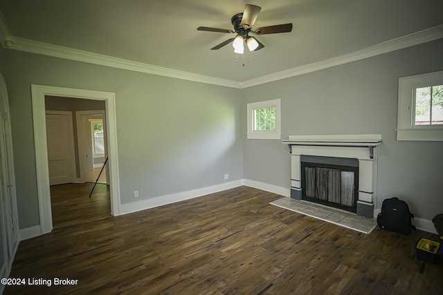 unfurnished living room with ornamental molding, ceiling fan, dark wood-type flooring, and a tiled fireplace