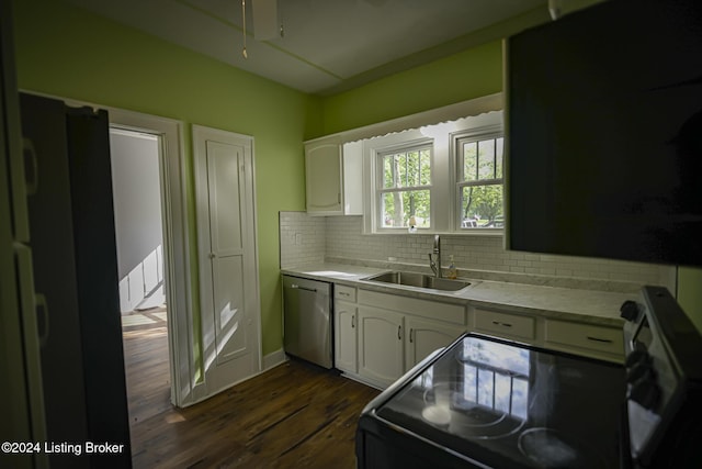 kitchen with stove, stainless steel dishwasher, sink, white cabinets, and dark hardwood / wood-style floors