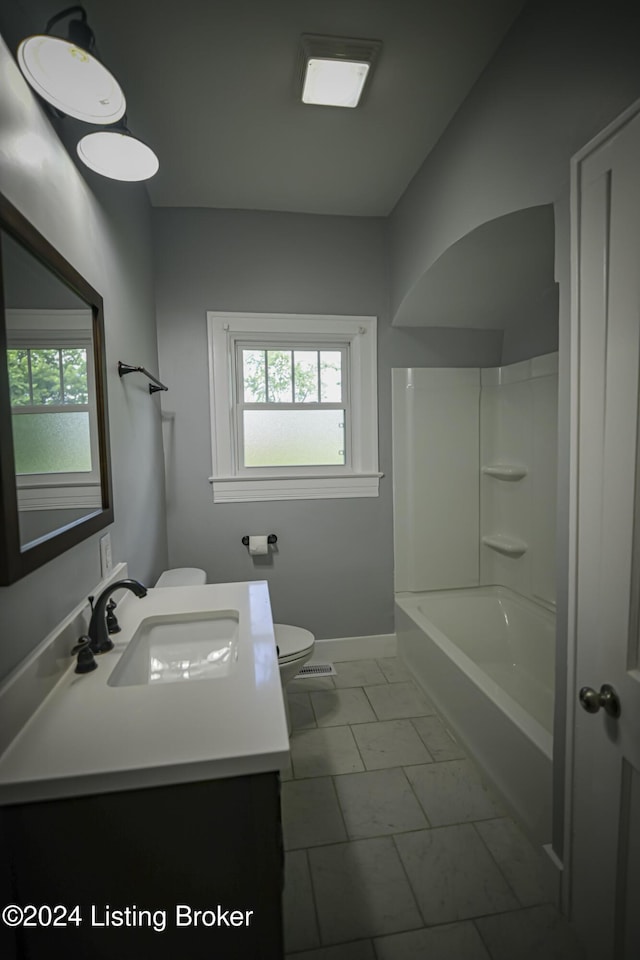 full bathroom featuring tile patterned flooring, vanity, toilet, and bathing tub / shower combination