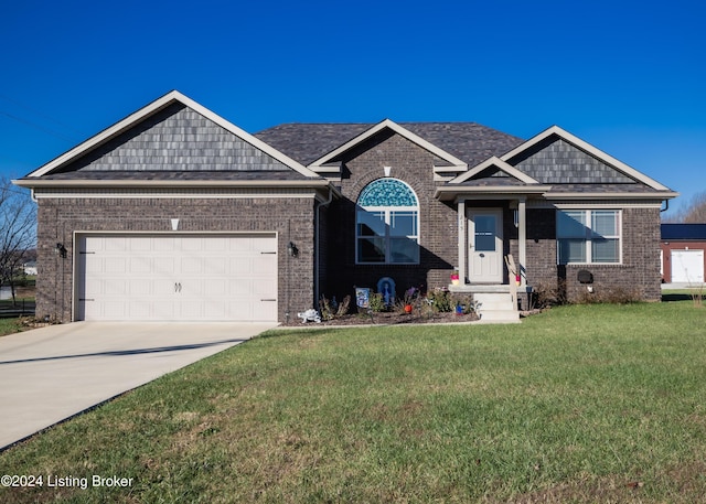 view of front of property with a garage and a front lawn