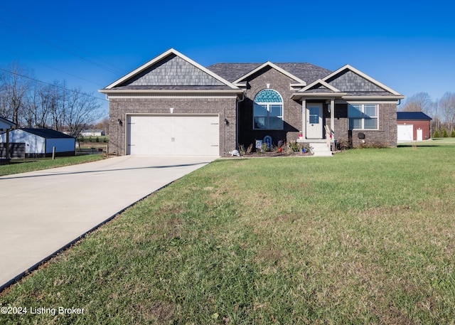 view of front of property featuring a front lawn and a garage