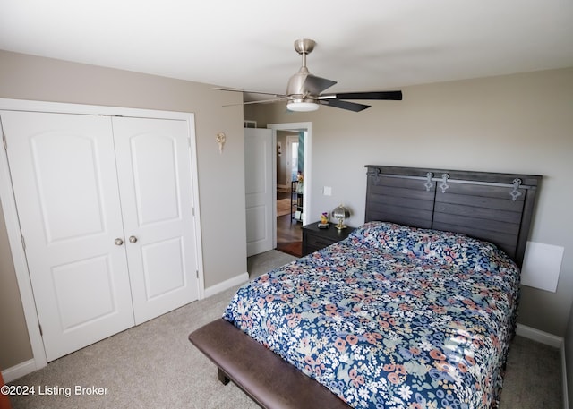 bedroom featuring ceiling fan, a closet, and light colored carpet