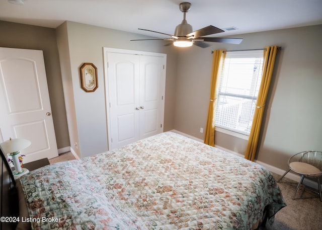 carpeted bedroom with ceiling fan and a closet