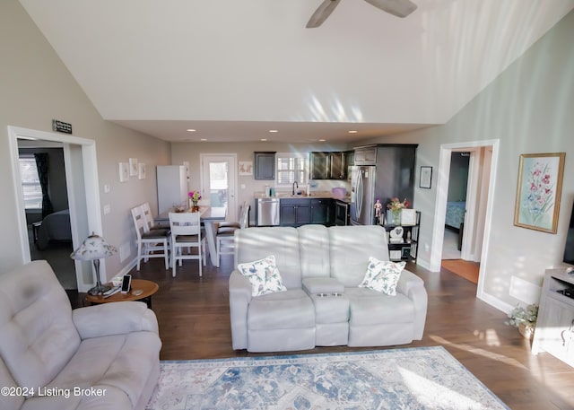 living room featuring dark hardwood / wood-style floors, high vaulted ceiling, ceiling fan, and sink