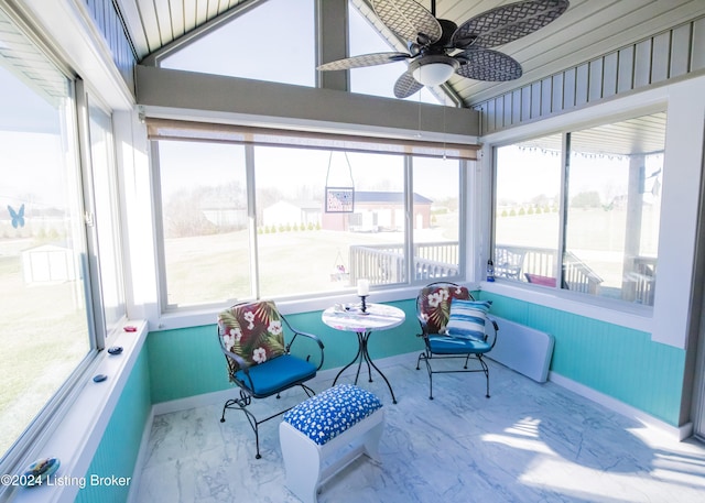 sunroom featuring a wealth of natural light, lofted ceiling, and ceiling fan