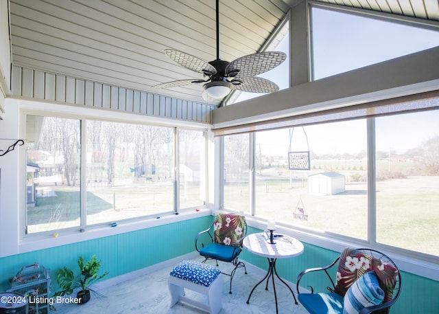 sunroom / solarium with ceiling fan and lofted ceiling