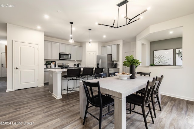 dining space with dark hardwood / wood-style floors and a notable chandelier