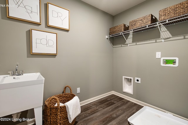 clothes washing area with hookup for an electric dryer, washer hookup, dark hardwood / wood-style floors, and sink