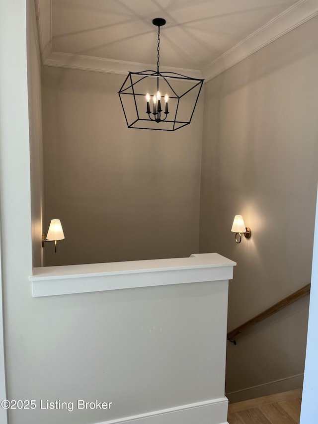 stairs featuring ornamental molding, a chandelier, baseboards, and wood finished floors