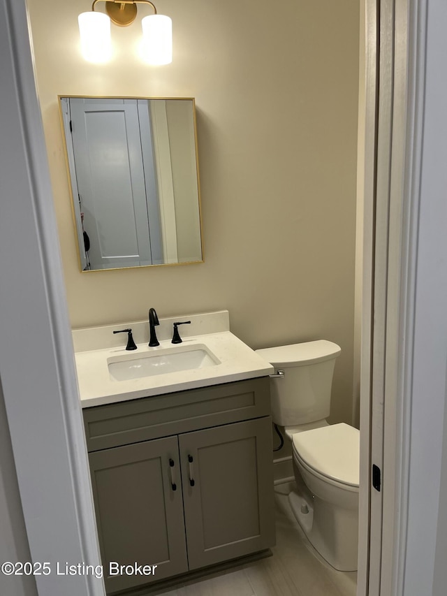 bathroom with toilet and vanity