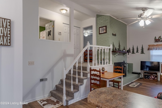 dining space featuring hardwood / wood-style floors, ceiling fan, and vaulted ceiling