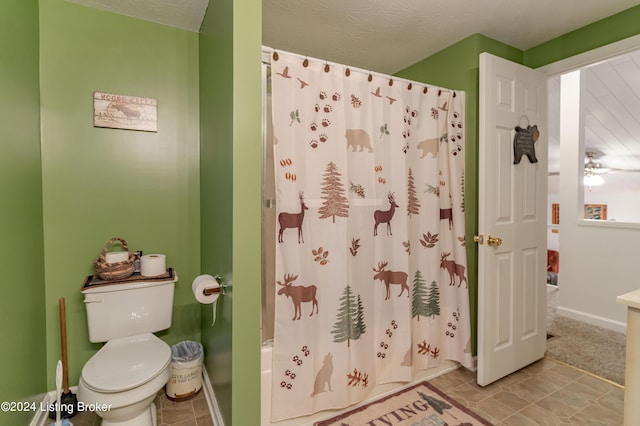 bathroom with tile patterned floors, shower / tub combo, toilet, and ceiling fan