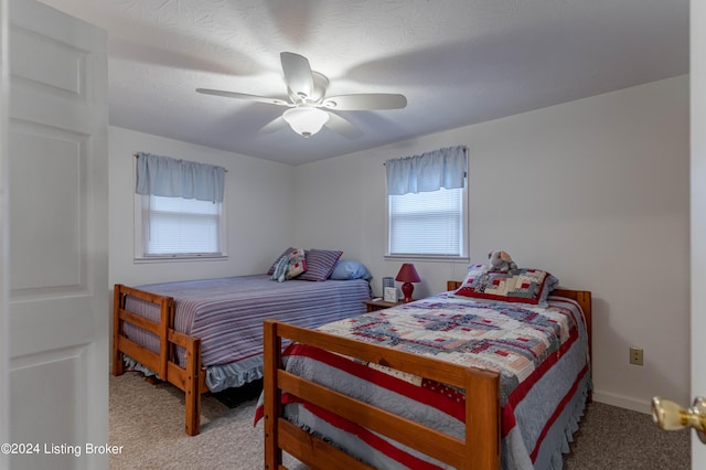 bedroom with ceiling fan and carpet floors