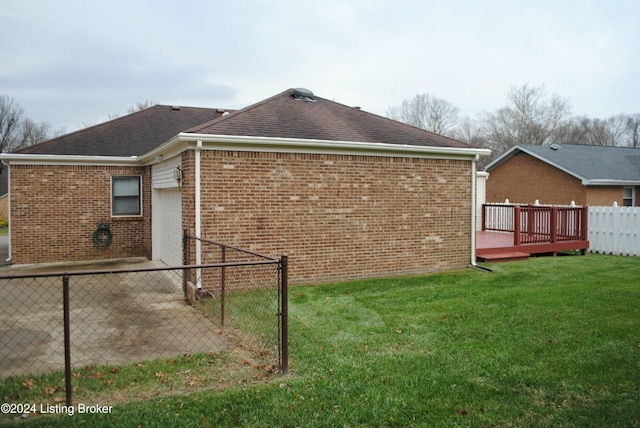 view of property exterior with a garage, a yard, and a wooden deck