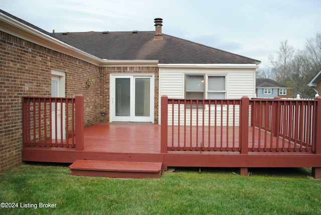 wooden deck featuring a lawn