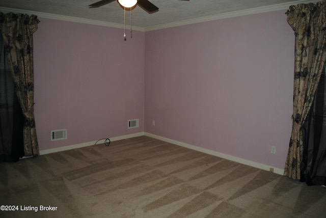 carpeted empty room featuring ceiling fan and ornamental molding