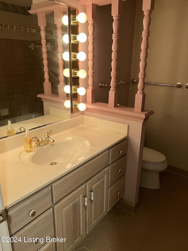 bathroom featuring tile patterned flooring, vanity, and toilet