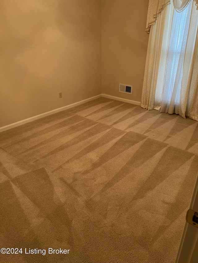 empty room featuring carpet flooring