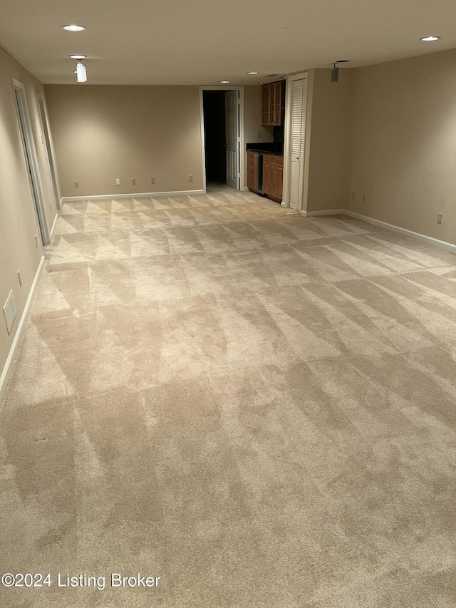 unfurnished living room with light colored carpet