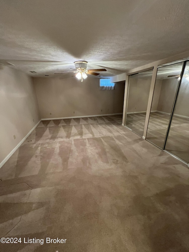 basement with carpet flooring and a textured ceiling