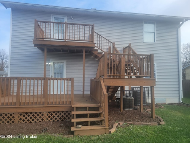 rear view of property featuring central air condition unit and a wooden deck