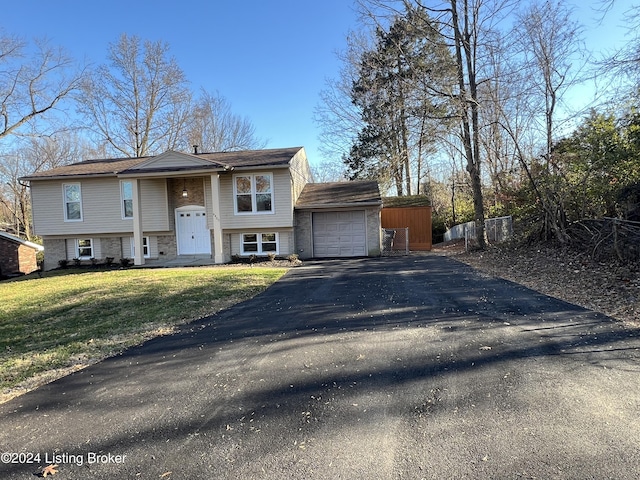 bi-level home featuring a front yard and a garage