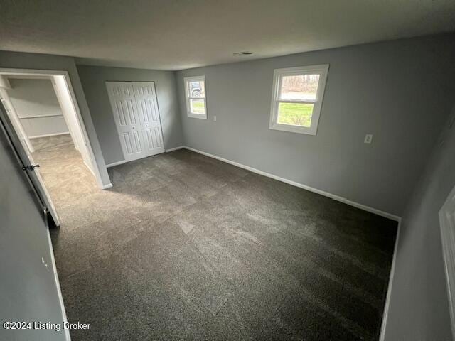 unfurnished bedroom with carpet flooring and a closet