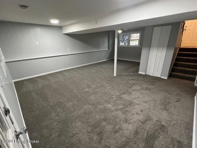 basement featuring dark carpet