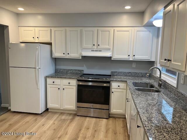 kitchen with sink, light hardwood / wood-style flooring, white fridge, stainless steel range with electric stovetop, and white cabinets