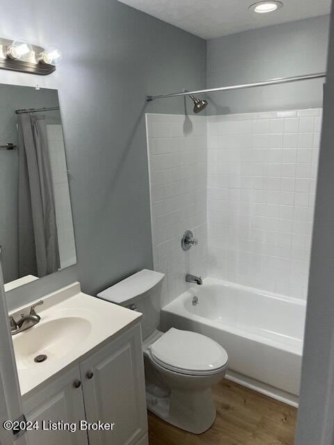 full bathroom featuring vanity, toilet, shower / tub combo, and wood-type flooring