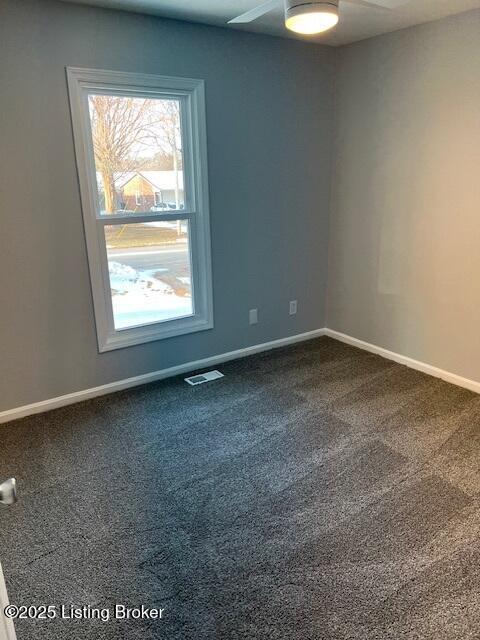 spare room featuring carpet floors and ceiling fan