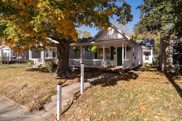 farmhouse inspired home with a porch and a front lawn