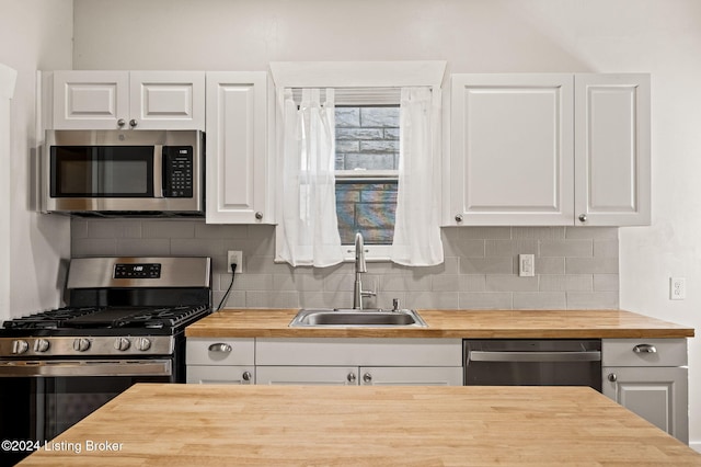 kitchen featuring sink, white cabinetry, and stainless steel appliances